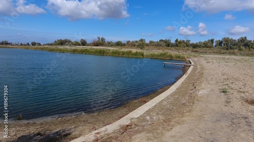 An artificial lake for fishing. A bridge for fishermen on the lake. Lake fishing