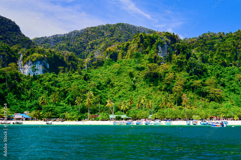 Speed boats on tropical beach in the Andaman sea, Thailand. View from the sea side