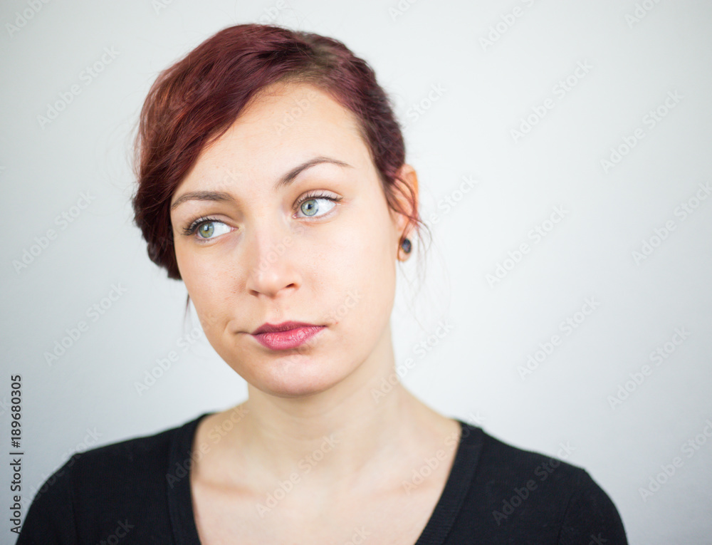 A young girl expressing her face, and her hands showing her idea, white background, studio, facial expressions A young girl expressing her face, and her hands showing her idea, white background, studio, facial expressions
