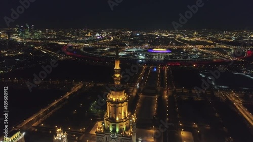 Moscow State University Main Campus and Illuminated Moscow Skyline at Clear Winter Night. Spire closeup. Russia. Aerial View. Drone is Flying Around. Establishing Shot.