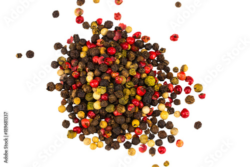 Black, red and white peppercorns isolated on white background. Heap of spice. Mix of different peppers photo