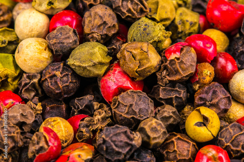  Mix of different peppers.Black, red and white peppercorns - food spicy background
