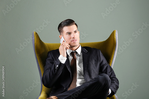 Man in elegant suit on grey...