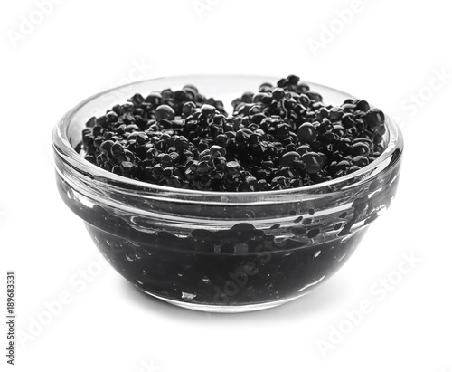 Black caviar in glass bowl on white background