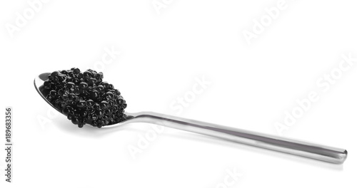 Black caviar in spoon on white background