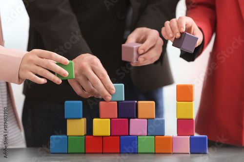 Obraz na płótnie Group of people with colorful cubes, closeup. Unity concept