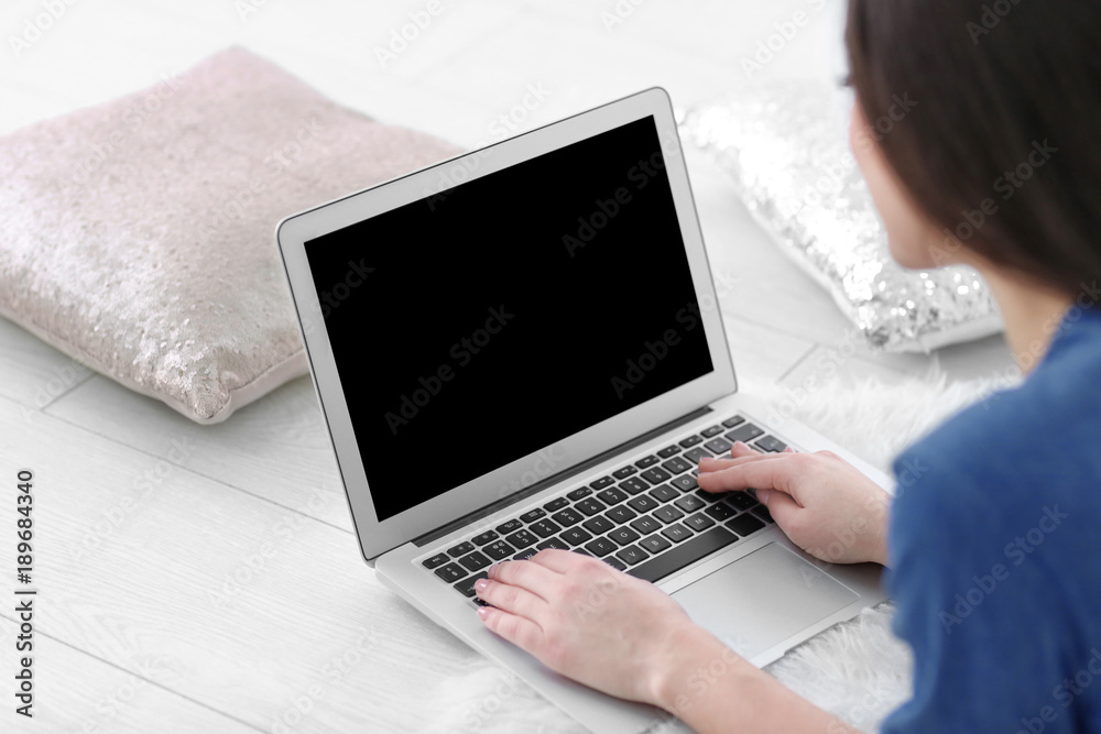 Woman using laptop indoors, closeup Woman using laptop indoors, closeup