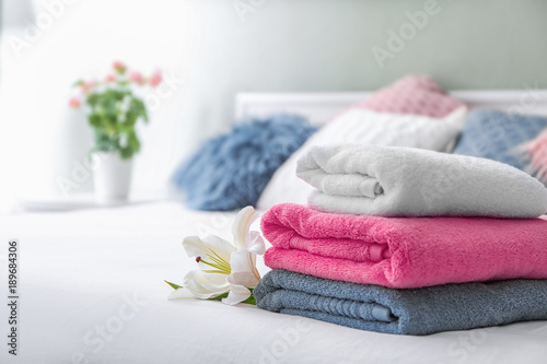 Fototapeta Naklejka Na Ścianę i Meble -  Stack of clean towels on bed