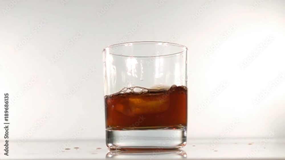 ice falls into a glass of water slow motion ice falls into a glass of water slow motion