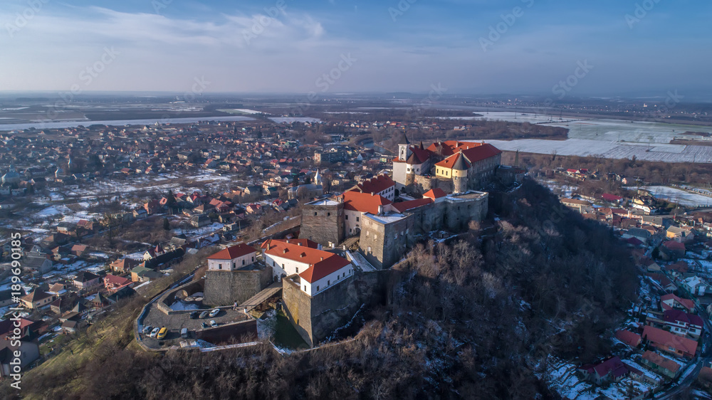 Beautiful panoramic aerial view to Palanok Castle at sunset and the city of Mukachevo