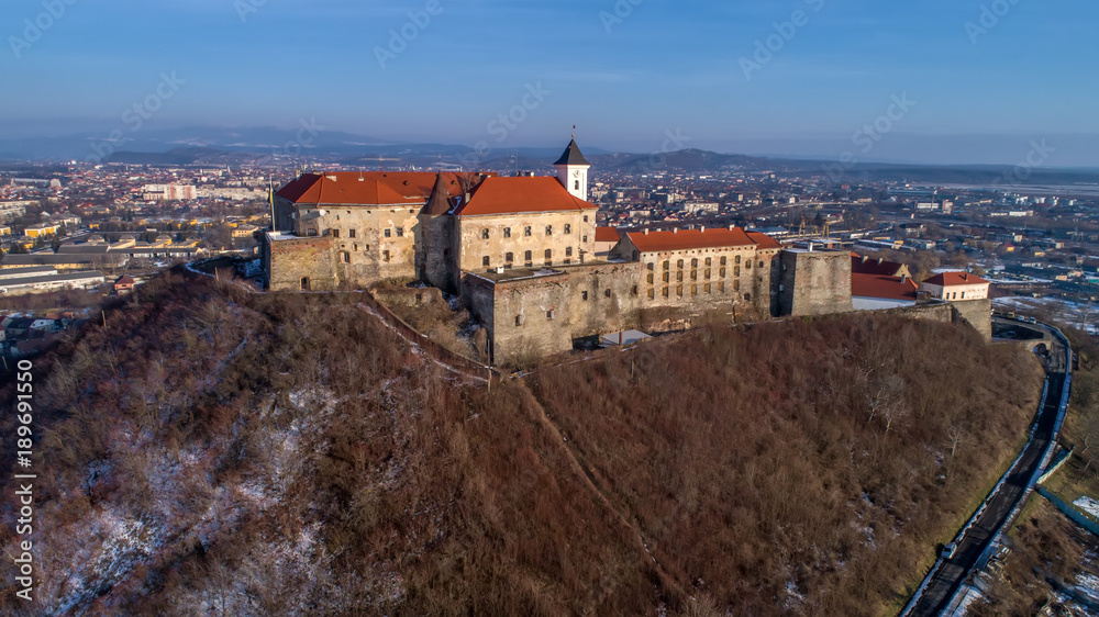 Beautiful panoramic aerial view to Palanok Castle at sunset and the city of Mukachevo