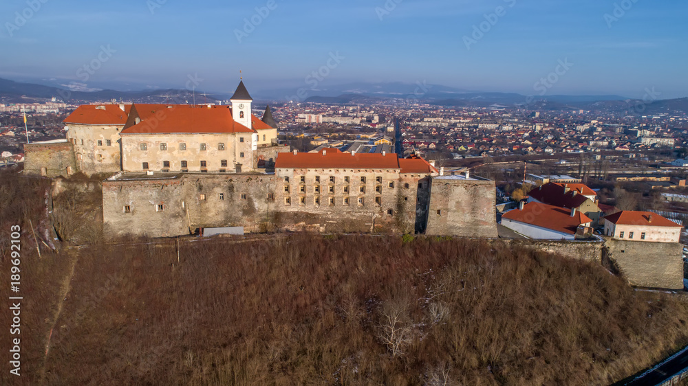 Beautiful panoramic aerial view to Palanok Castle at sunset and the city of Mukachevo
