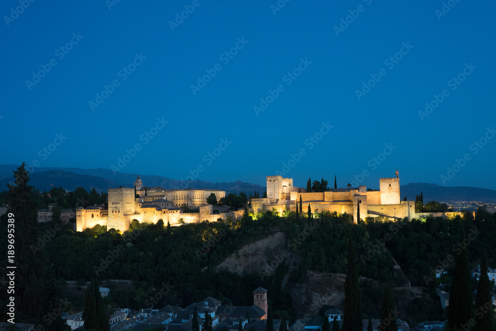 The magnificient Alhambra of Granada, Spain. Alhambra fortress at sunset viewed from Mirador de San Nicolas
