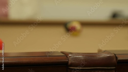 A dolly shot of lady playing pool in a retirement home photo