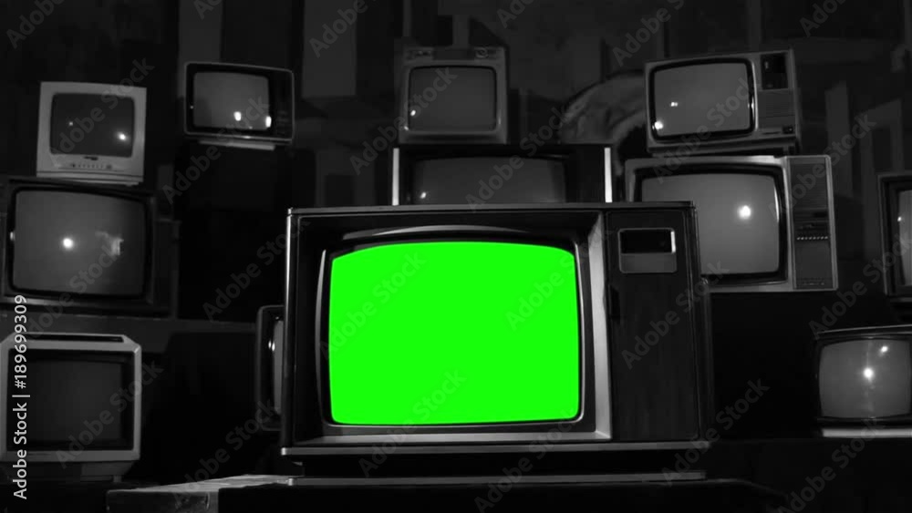 Old Tv Green Screen in a Pile of Old Tvs. Black and White Tone. You can replace green screen with the footage or picture you want with “Keying” effect in AE  (check out tutorials on YouTube). 