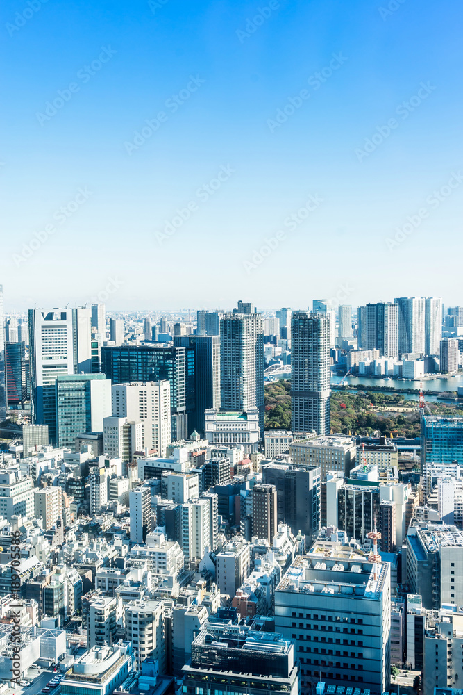Asia Business concept for real estate and corporate construction - panoramic modern city skyline bird eye aerial view near tokyo tower under bright sun and vivid blue sky in Tokyo, Japan
