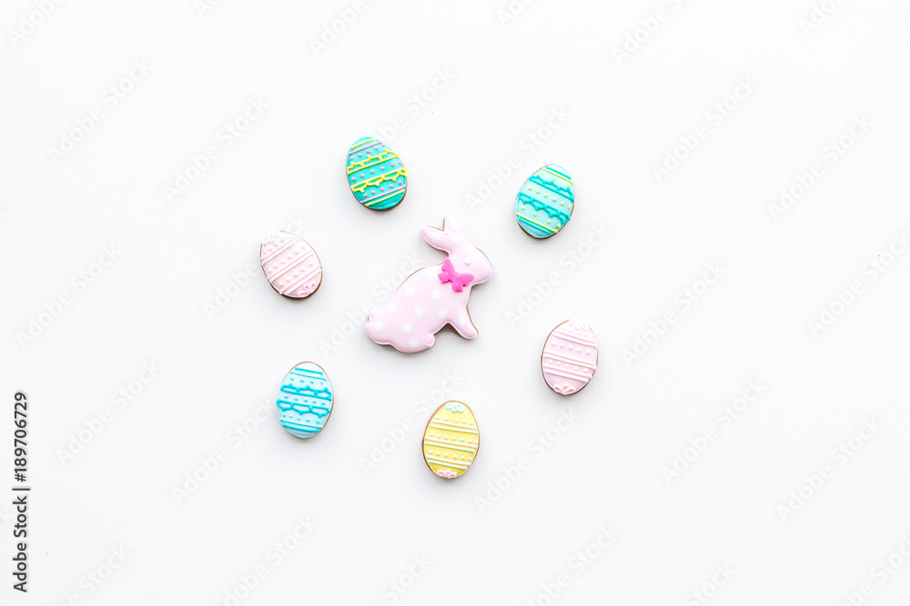 Easter background. Cookies in shape of easter bunny and easter eggs. White background top view space for text Easter background. Cookies in shape of easter bunny and easter eggs. White background top view space for text