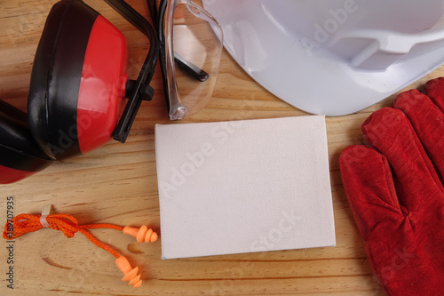 HEALTH AND SAFETY CONCEPT. Personal protective equipment on wooden table background. Copy space photo