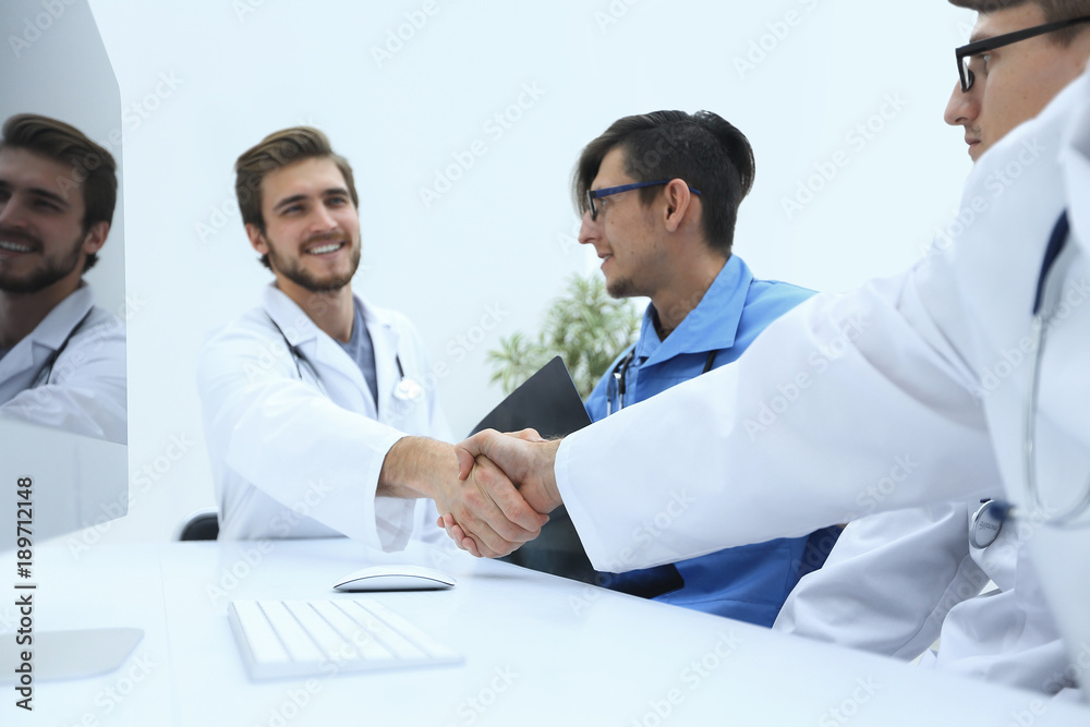 handshake between the two doctors during the working meeting handshake between the two doctors during the working meeting