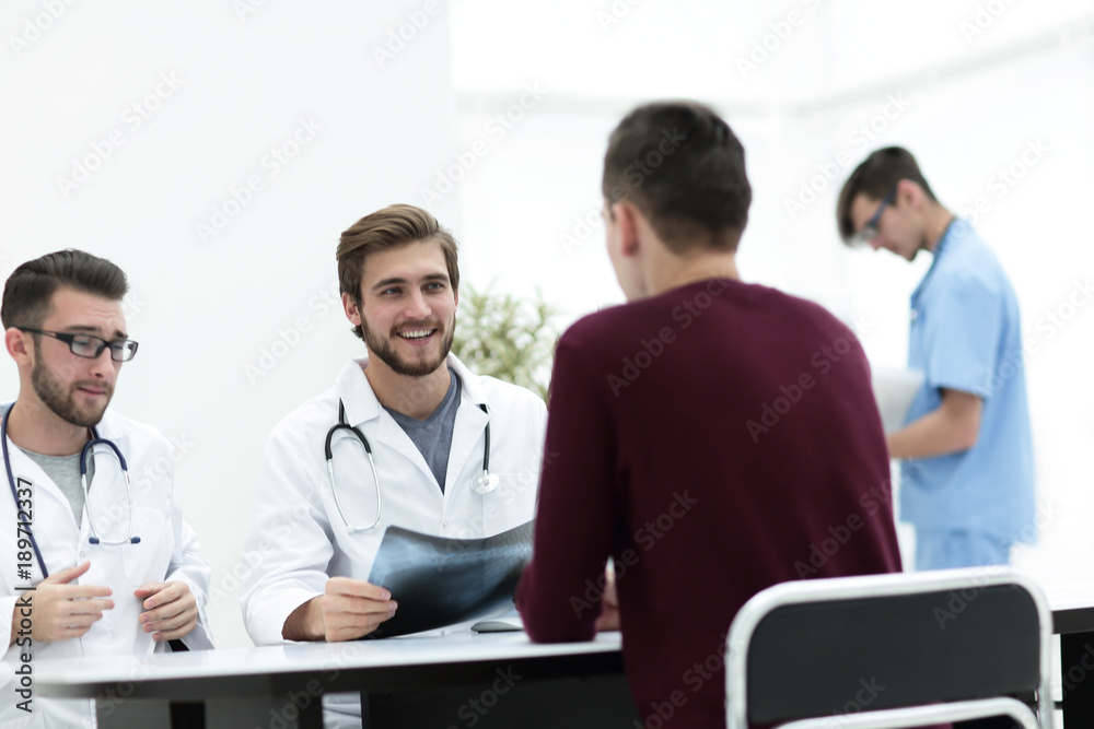 doctors discuss with the patient the x-ray doctors discuss with the patient the x-ray