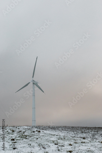 A wind turbine on a mountain covered by snow near Colfiorito town (Umbria, Italy)