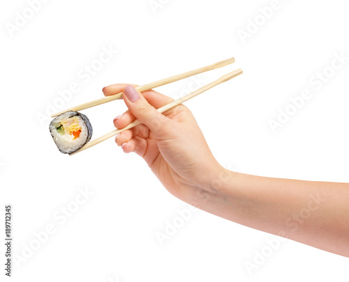 Sushi roll with wooden chopsticks in female hand, isolated on white background