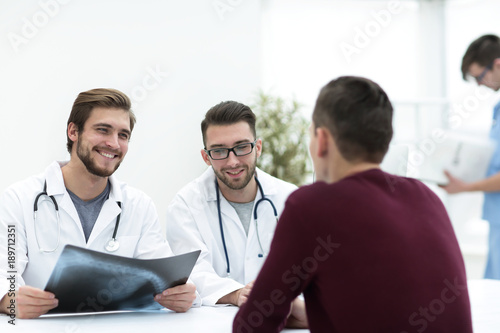 group of doctors welcoming their customer with a handshake