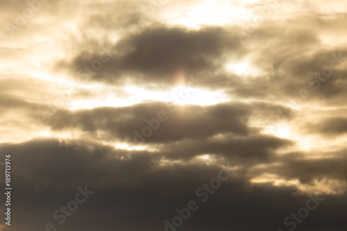 The sun hid behind black clouds as a background