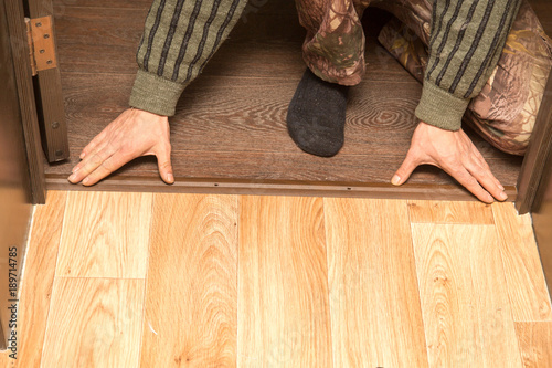 A man is making a threshold on the floor photo