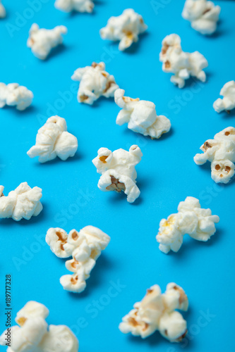 Vertical pattern of popcorn on a blue background.