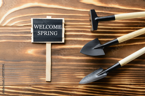 Welcome Spring sign with tools on table photo