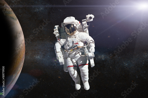 Fototapeta Naklejka Na Ścianę i Meble -  Astronaut in outer space on background of the planet. Elements of this image furnished by NASA.