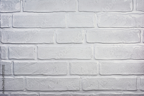 Light gray grunge textured brick wall