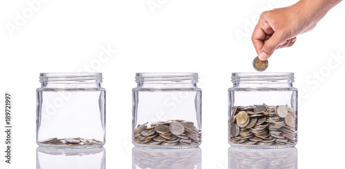 Obraz na płótnie Thai coin (baht) in clear glass jar with different level from less to more