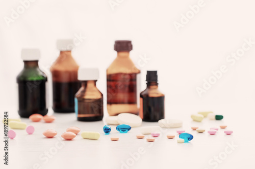 Composition of medicine bottles and pills on white background