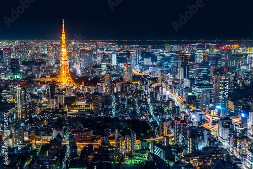 Asia Business concept for real estate & corporate construction - panoramic modern city skyline of Tokyo Tower and Tokyo Metropolitan Expressway junction with neon night in Roppongi Hill, Tokyo, Japan