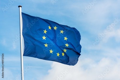 European flag waggling in the wind with blue sky