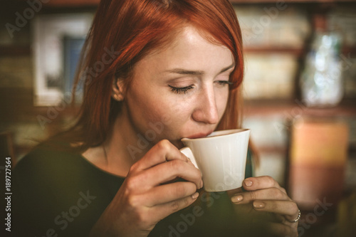 Coffee time. Young business woman enjoy in coffee break.
