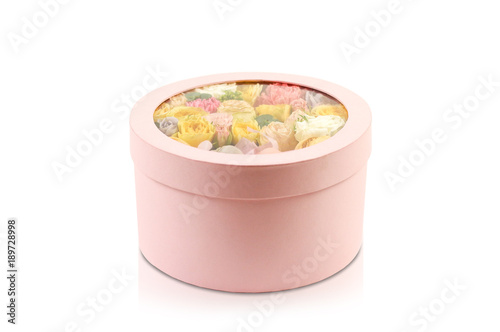 Flowers and cookies in a box. Rocket in a hatbox. Close up. On a white background