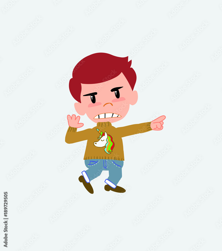 White boy with a unicorn pullover points angrily to his left. White boy with a unicorn pullover points angrily to his left.