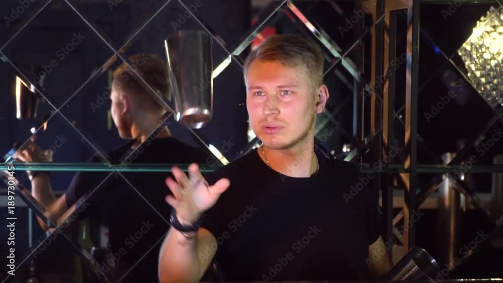 The bartender performs tricks with bottles and glasses Slow-mo The bartender performs tricks with bottles and glasses Slow-mo