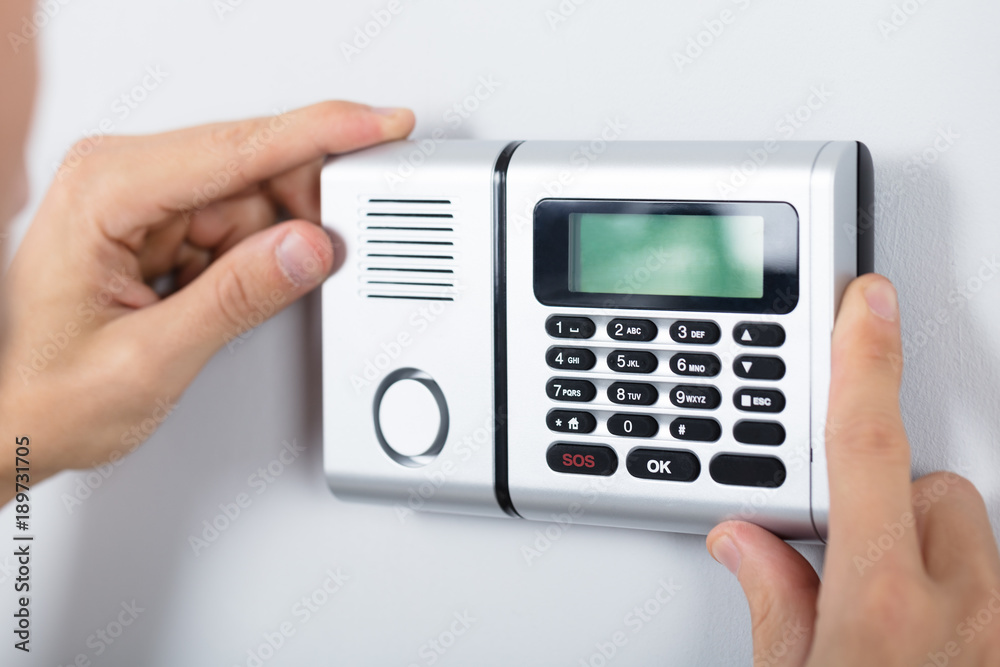 Repairman Installing Security System Repairman Installing Security System
