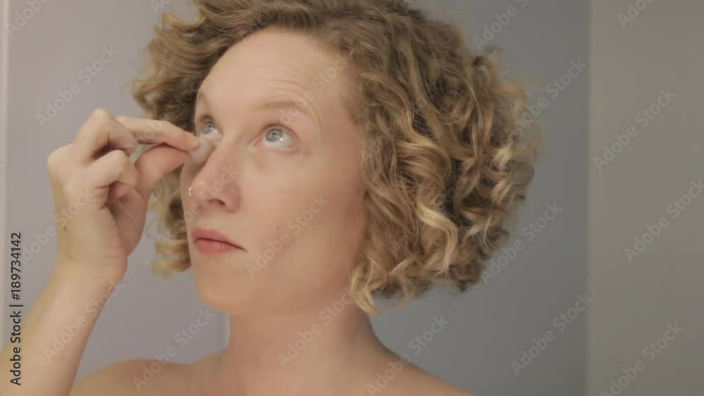 Young woman applying makeup. Getting ready for the day. Young woman concealing under-eye circles. Right-handed. Young woman applying makeup. Getting ready for the day. Young woman concealing under-eye circles. Right-handed.