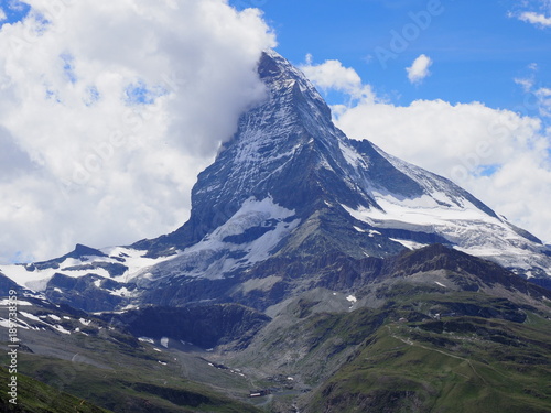 Matterhorn peak in clouds and alpine mountains range landscape in swiss Alps seen from Gornergrat in SWITZERLAND