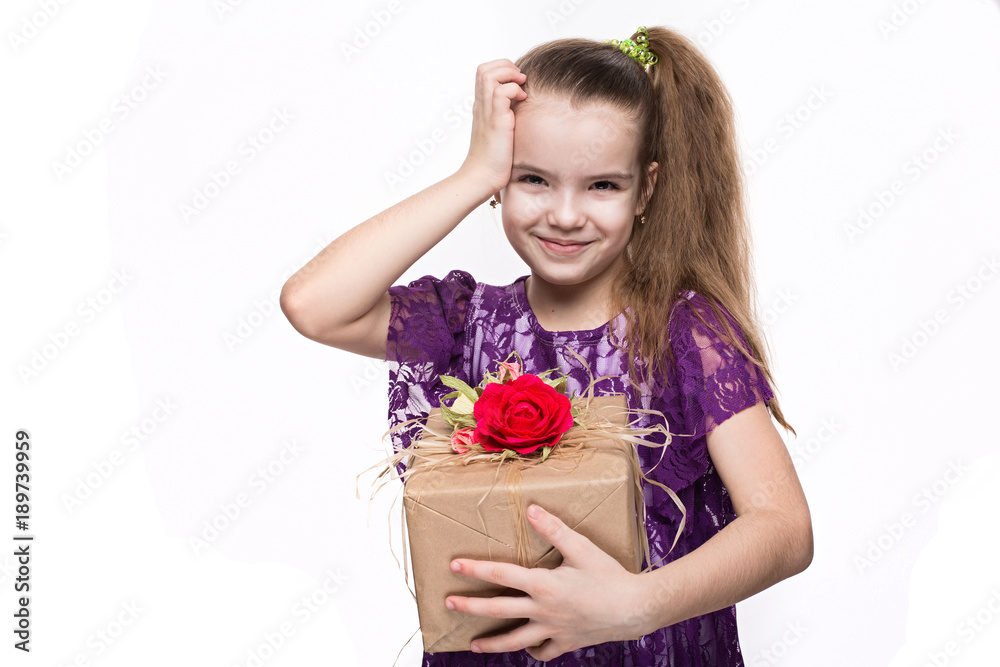 Beautiful caucasian girl in purple lace dress holding a box with a gift decorated with flowers. Shooting in studio on isolated white background Beautiful caucasian girl in purple lace dress holding a box with a gift decorated with flowers. Shooting in studio on isolated white background