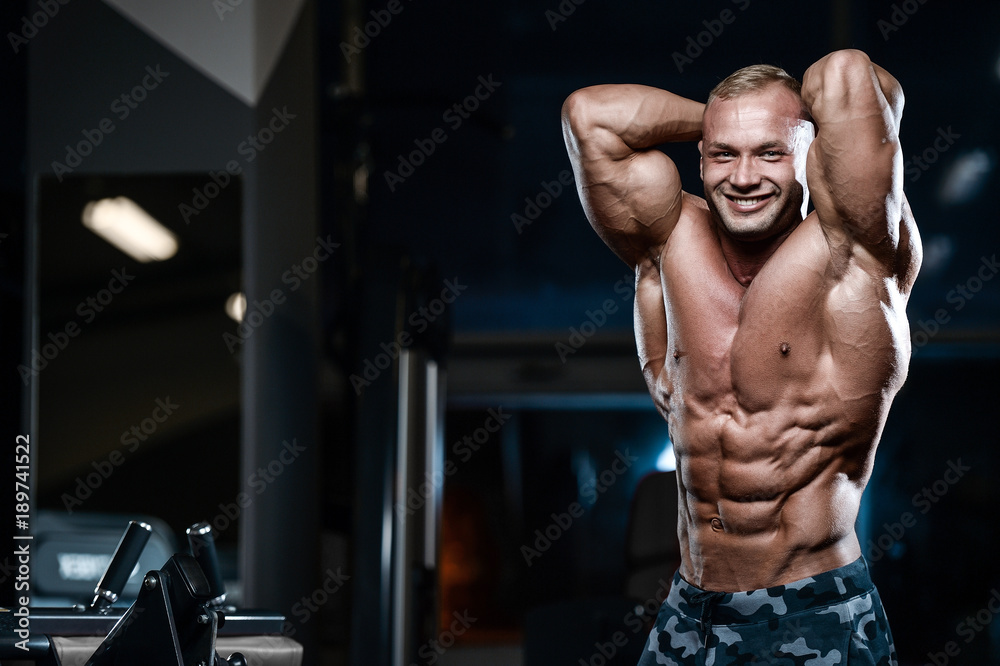 Brutal strong bodybuilder athletic men pumping up muscles with dumbbells. Brutal strong bodybuilder athletic men pumping up muscles with dumbbells.