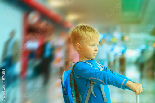 little boy with suitcase travel in the airport