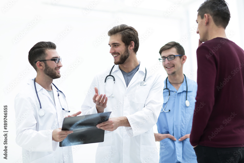 group of doctors discussing a patient's x-ray group of doctors discussing a patient's x-ray