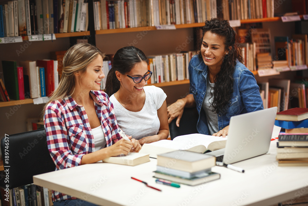 Female students study in the college library.Learning and preparing for exam. Female students study in the college library.Learning and preparing for exam.