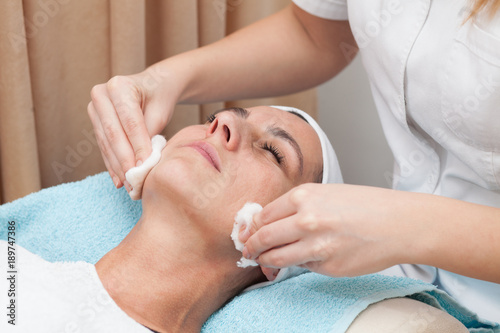 young woman having facial treatment in beauty salon © aerogondo